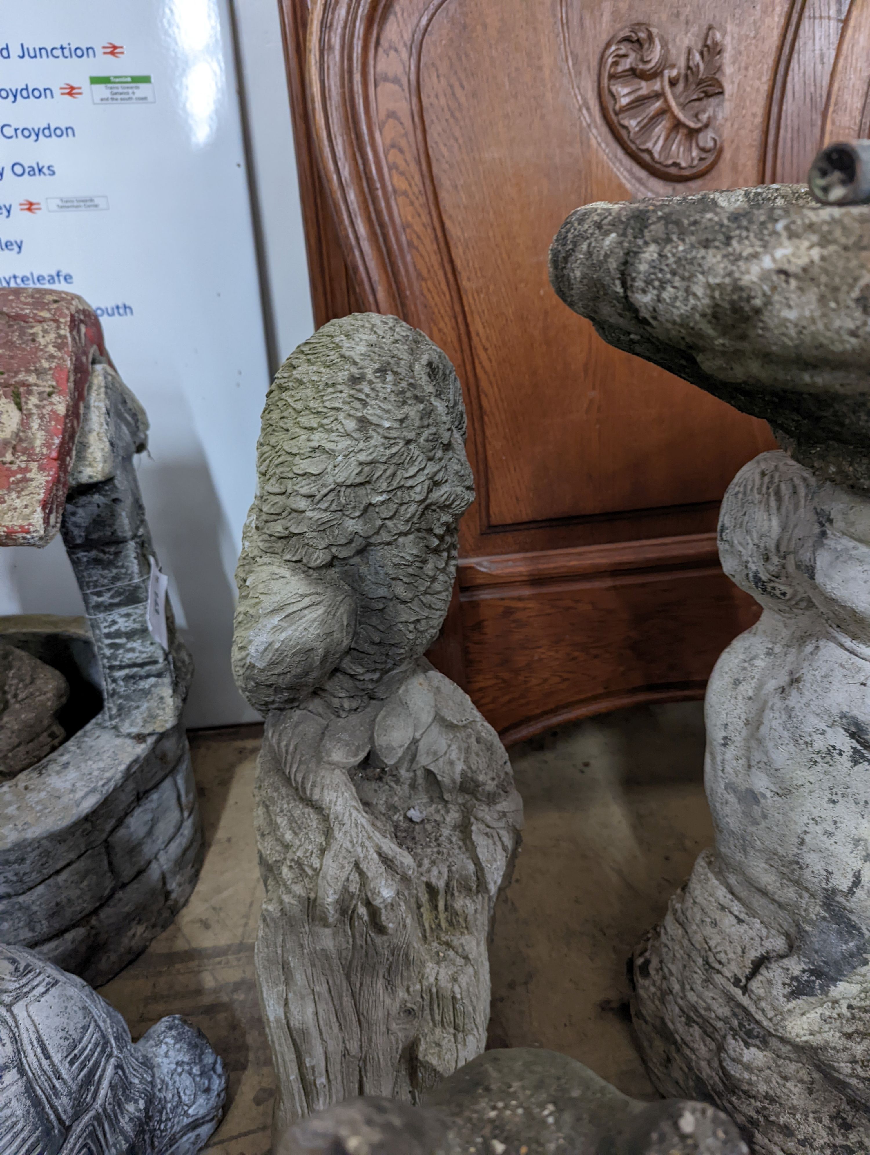 A reconstituted stone garden bird bath, height 59cm, together with four stone garden ornaments